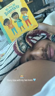 a man laying in bed with his head on the pillow while reading a children's book