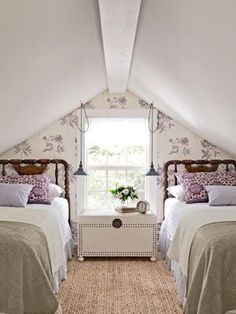 two beds in a room with white walls and carpeted flooring on the side