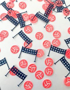 a bunch of red and black buttons sitting on top of a white table next to each other