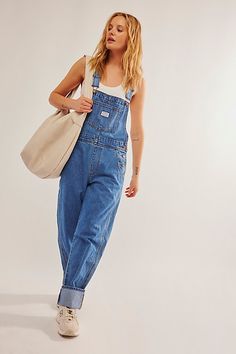 The perfect vintage-inspired overalls from Levi's, this distressed style is featured in a classic bib-and-brace silhouette with front pouch pocket and relaxed, straight leg design. * Adjustable straps * Four pocket design * Side button closures * Logo patch detail at front | Levi's Vintage Overalls at Free People in Medium Wash, Size: S Cute Overall Outfits, Overalls Outfits, Vintage Summer Outfits, Cute Overalls, Vintage Overalls, Overall Outfit, Modest Summer Outfits, Summer Dress Outfits, Summer Outfits Men