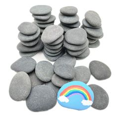 a pile of rocks with a rainbow painted on them