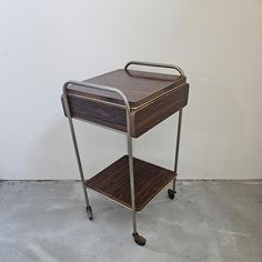 a metal and wood serving cart on wheels