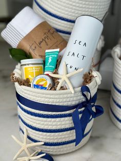 a basket filled with personal care items on top of a white counter next to starfish