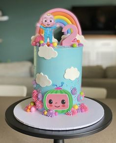 there is a cake that looks like pep the pig on top of it and rainbow decorations