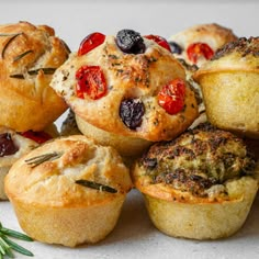 a pile of muffins with different toppings on them