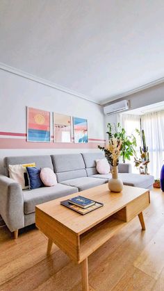 a living room filled with furniture and a wooden coffee table in front of a window