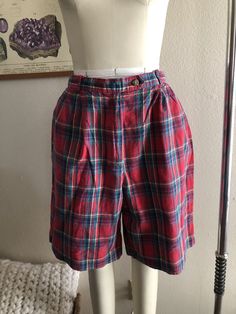 Vintage high rise plaid shorts, good condition, women's size 12 runs smaller. Shown here on a women's size 4 mannequin. Please use measurements for reference as vintage sizes vary. Measurements laying flat, not doubled 13.75 inch waist (also has elastic on the back of waistband) 21 inches in length All sales final, thanks for looking :) Plaid Short Bottoms For Fall, Fall Plaid Shorts, Fitted Plaid Shorts, Vintage Plaid Bottoms For Summer, Plaid High-waisted Fitted Shorts, High Waist Plaid Cotton Shorts, Fitted Plaid High-waisted Shorts, Plaid High Waist Cotton Shorts, High-waisted Plaid Bottoms With Built-in Shorts