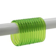 a green and white plastic tube on a white pole