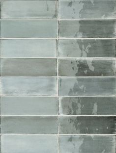 a tile wall that has been painted gray and white