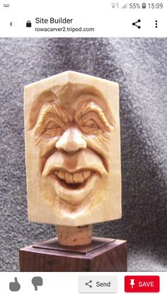 a wooden block with a carved face on it's head and the words site builder below