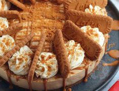 a cake covered in whipped cream and cookies