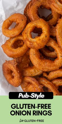 a pile of onion rings sitting on top of a piece of paper with the title pub style gluten - free onion rings