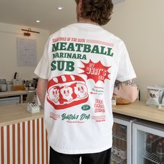 Sandwich of the day!Organic cotton white t-shirt with Batch1 Deli Meatball Sub poster print and vintage style sandwich character. Small logo to front, large back print. Printed t-shirt by Batch1Slogan: "Meatball Marinara Sub - Hey What's Sub!"Graphics: Small logo to front, large back print. Meatball sub sandwich poster print. Print: Organic, water-based, eco-friendly inkStyle: Crew neck, short sleeves, soft jersey Crew Tshirt Design, Meatball Marinara, Sub Sandwich, Meatball Sub, Sub Sandwiches, Sandwich Shops