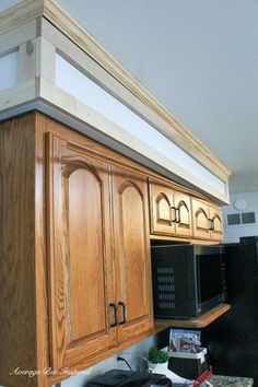 a kitchen with wooden cabinets and black appliances