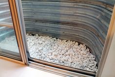 the inside of a window with gravel in it