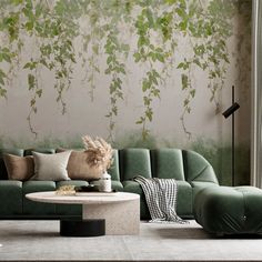 a living room with green couches and wallpaper on the walls in front of it