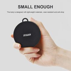 a hand holding a small black speaker in it's right hand with the word ina on it