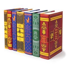 the harry potter books are lined up in different colors and designs, with one book open