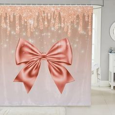 a pink shower curtain with a large bow on it's side and sparkles in the background