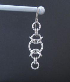 These earrings are woven together in a chainmaille pattern with stainless steel jump rings. The ear wires are hypoallergenic titanium. I think they are kind of fun and funky. They are just under 2 inches (5 cm) long, and just under 1/2 an inch (1.3 cm) wide. I have more chainmaille jewelry listed here: https://www.etsy.com/shop/BlackCatLinks/search?search_query=chainmaille&order=date_desc&view_type=gallery&ref=shop_search All of my earrings are listed here: https://www.etsy.com/shop/ Metal Earrings With Hook And Links For Gifts, Chainmaille Jewelry Patterns, Chainmaille Earrings, Jump Ring Jewelry, Chainmaille Jewelry, Chainmail Jewelry, Earrings Chain, Safety Pin Earrings, Hammered Hoop Earrings