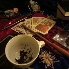 a table topped with cards and a cup filled with dirt