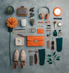 the contents of a purse laid out on a table next to a flower and other items