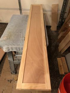 a bench made out of plywood is sitting in the process of being built and assembled