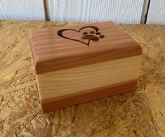 a wooden box with a dog's paw and heart on it