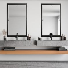 there are two sinks with mirrors above them