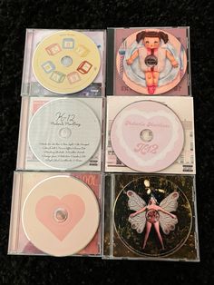 four cd's are sitting on top of each other