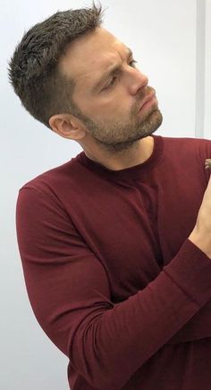 a man is brushing his teeth in front of a mirror with an electric toothbrush