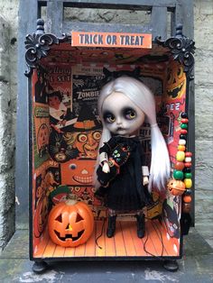 there is a doll in a box with halloween decorations