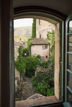 an open window looking out onto a small village