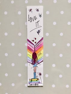 a bookmark with the words love it and a drawing of a girl holding a rainbow umbrella