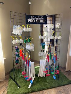 several umbrellas are on display in front of a pro shop sign