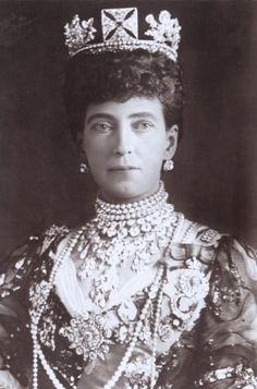 an old black and white photo of a woman wearing a tiara