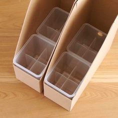 two boxes with compartments are sitting on a table