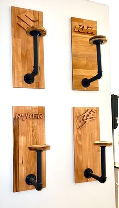 three wooden hooks are attached to the wall