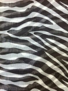 an animal print fabric with black and white stripes