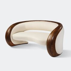 the curved chair is made out of wood and white upholstered fabric, with a wooden