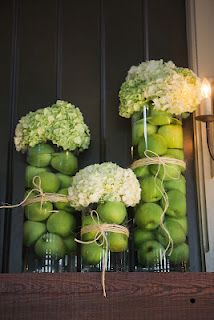 green apples and white hydrangeas tied together in mason jars