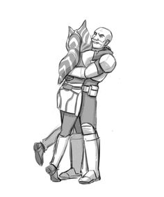 two people hugging each other with their arms around one another, and the man is wearing armor