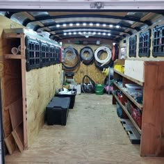 the inside of a truck with lots of tires and other items in it's storage area