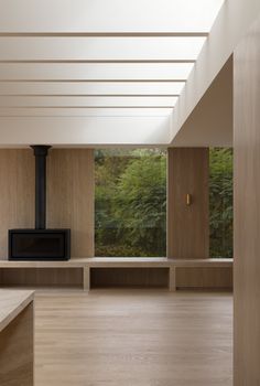 an empty room with wood paneling and large windows