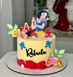 there is a cake that has snow white on it and the letters are made out of fondant