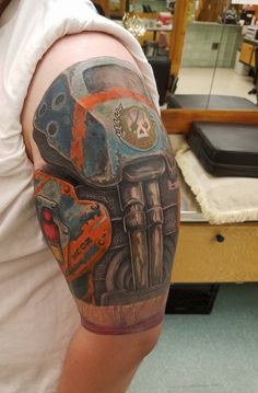 a man with a motorcycle tattoo on his arm