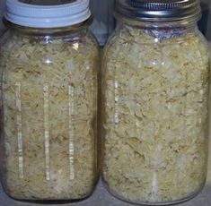 two glass jars filled with rice sitting on top of a counter