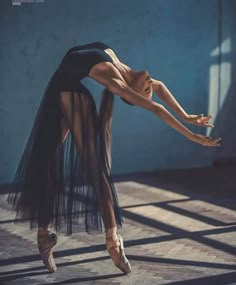 a ballerina is posing for the camera with her arms stretched out and legs bent