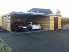 two cars are parked in front of a garage