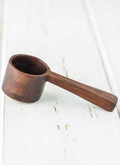 a wooden spoon sitting on top of a white table